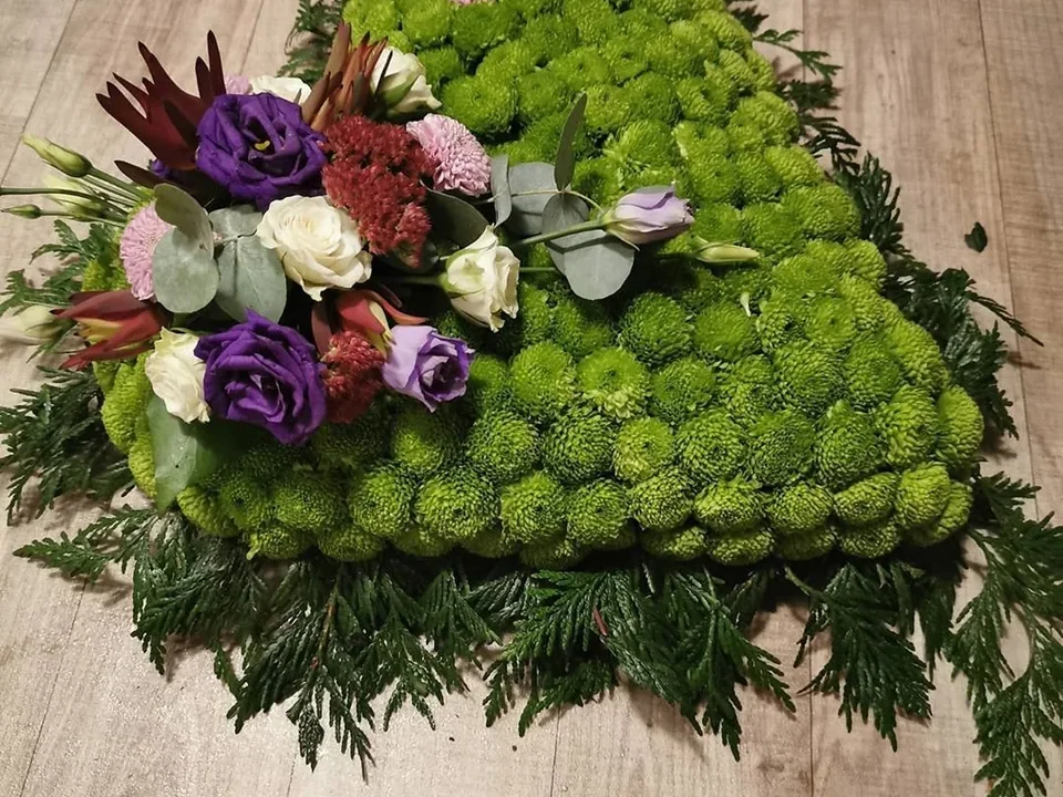Purple and green heart-shaped sympathy tribute