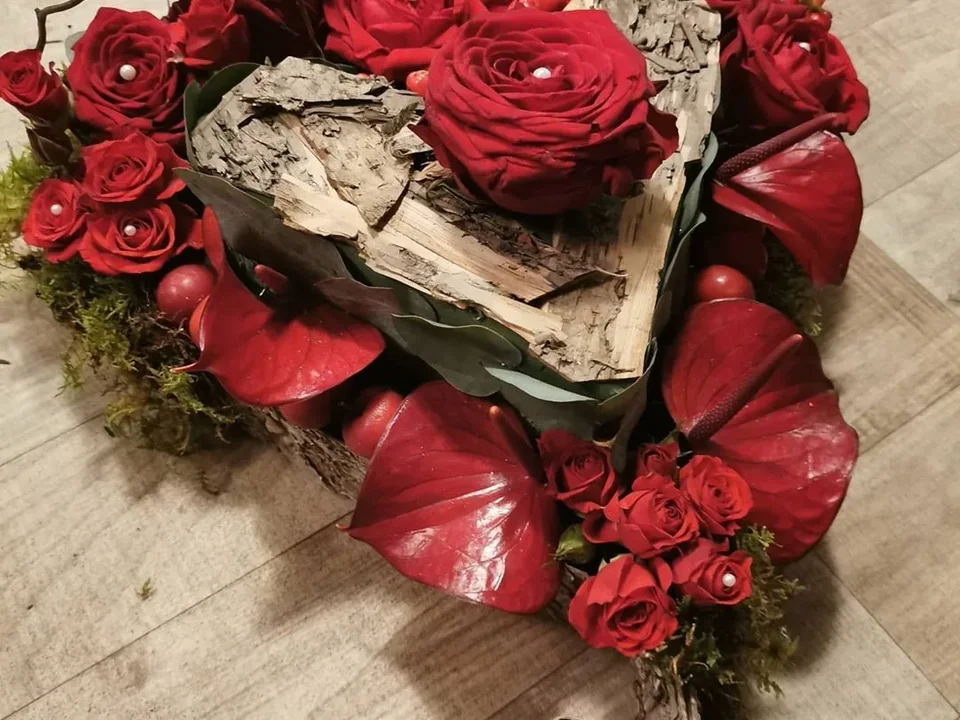Rustic woodland heart tribute with red roses